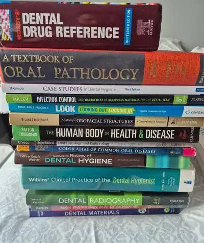 Stack of essential books for 1st year BDS students including Anatomy, Physiology, Biochemistry.